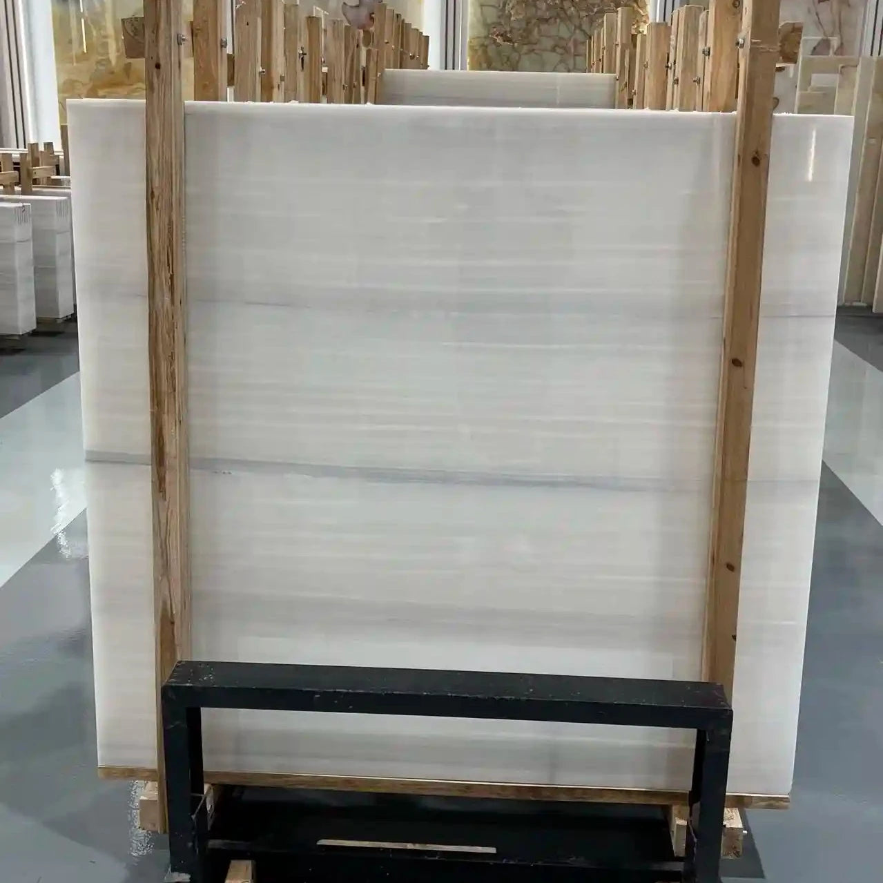 Athens White Onyx marble slab in a smooth white tone, perfect for high-end interior design projects.