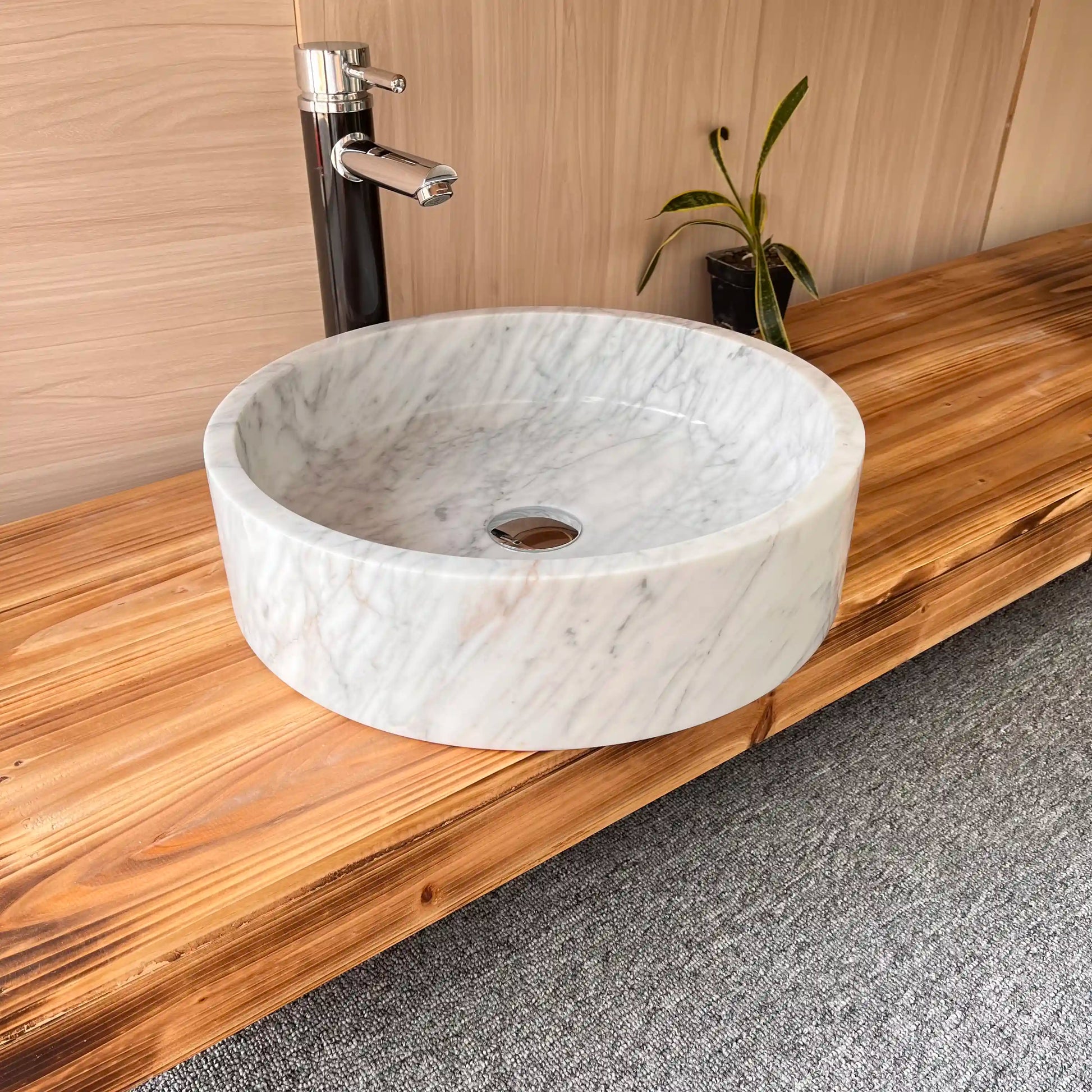 Flat-bottom round marble sink with custom options available.