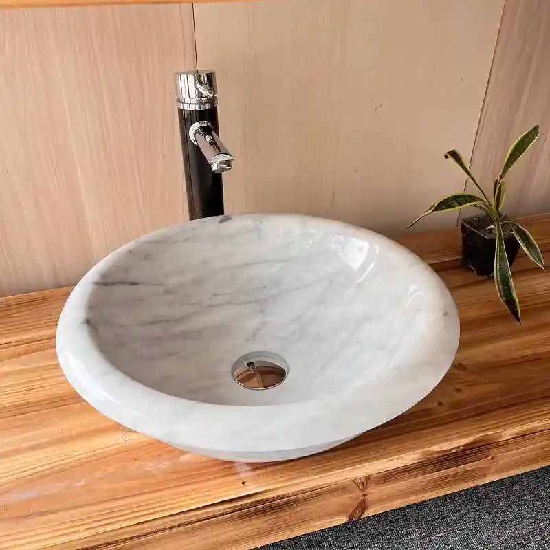 Flat-bottom round marble sink with custom options available.