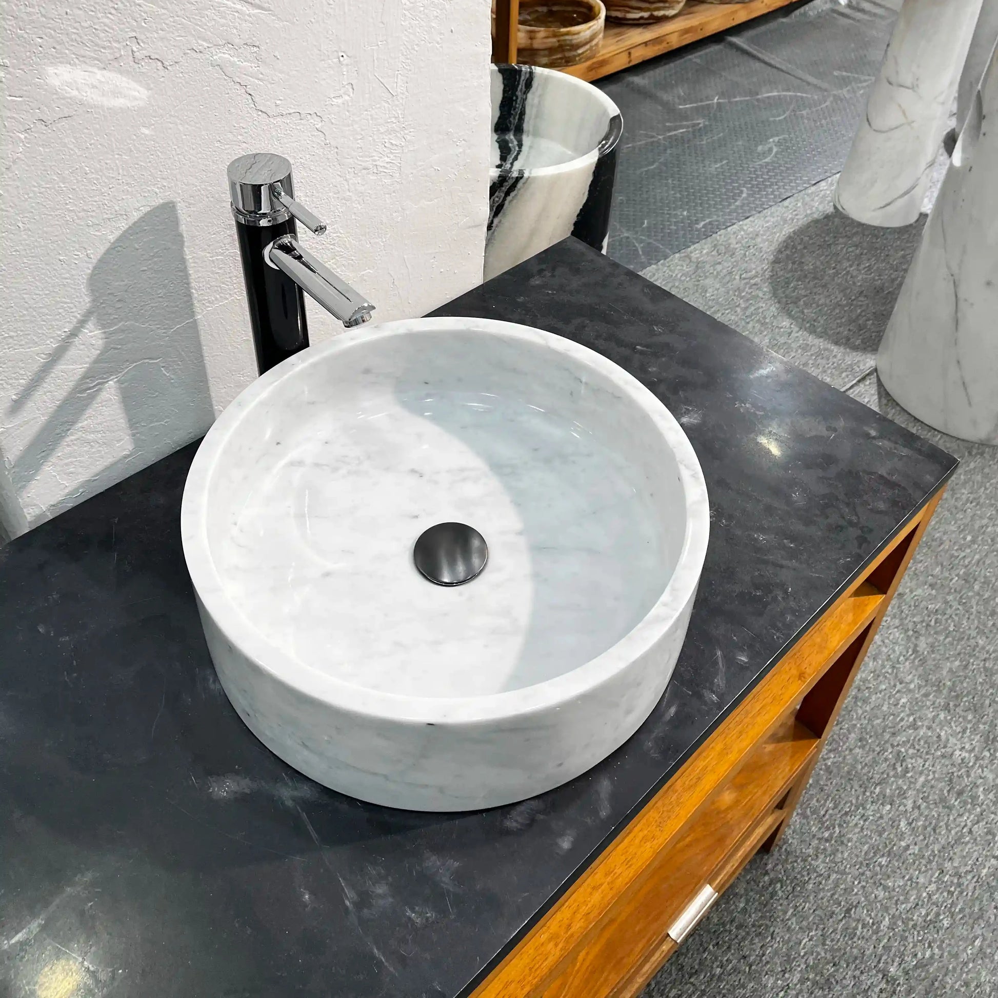 Flat-bottom round marble sink with custom options available.