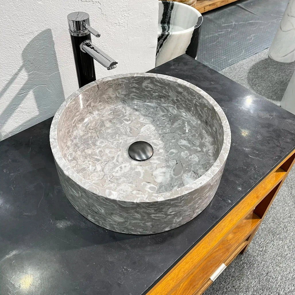 Flat-bottom round marble sink with custom options available.