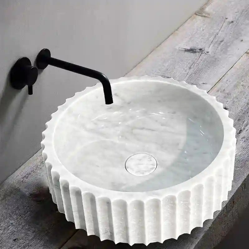 Fluted polygonal marble sink with custom options available.