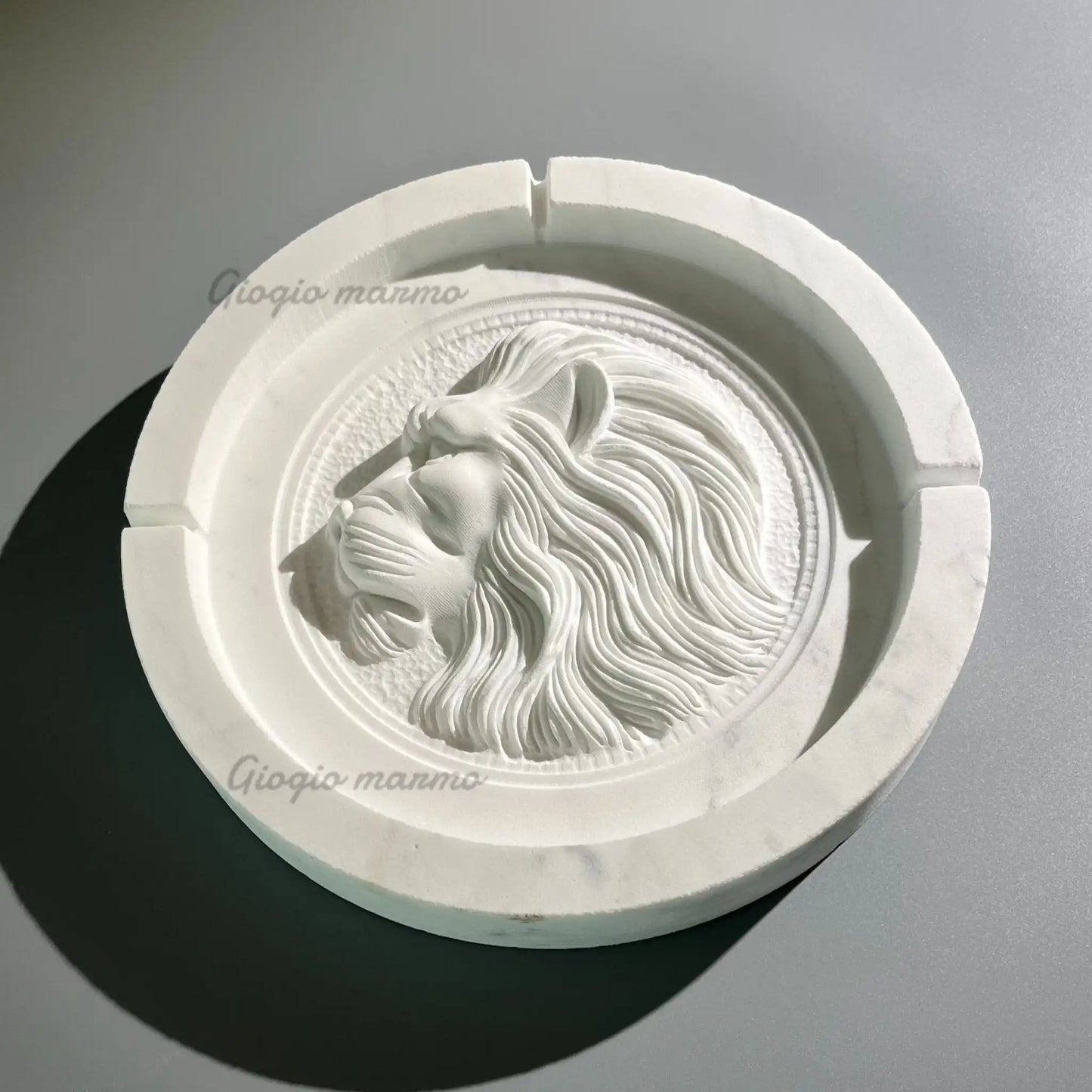 Intricately carved lion head marble plate