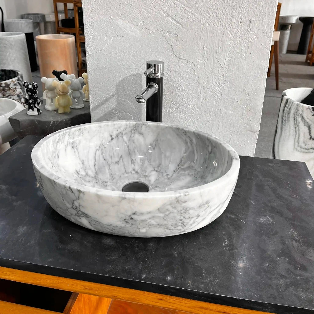 Oval marble sink with custom options available.