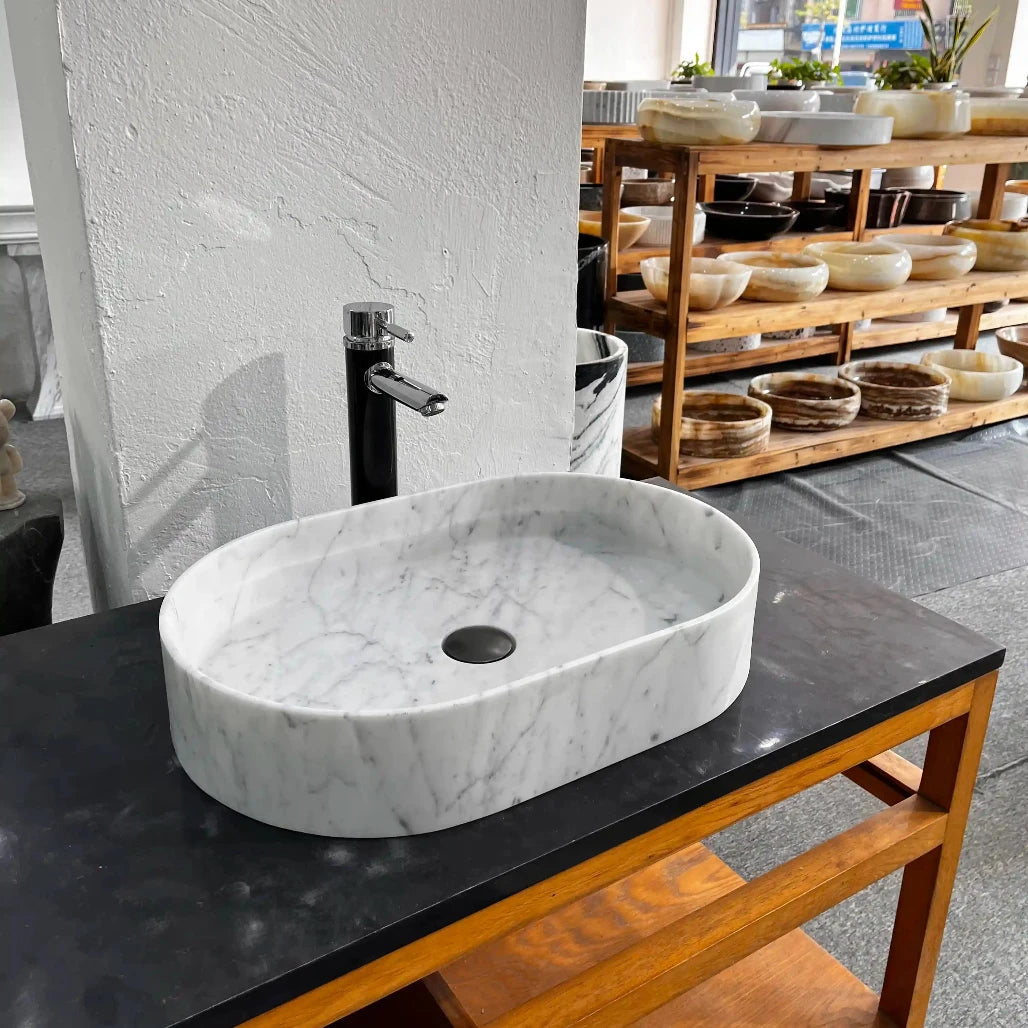 Oval marble sink with custom options available.