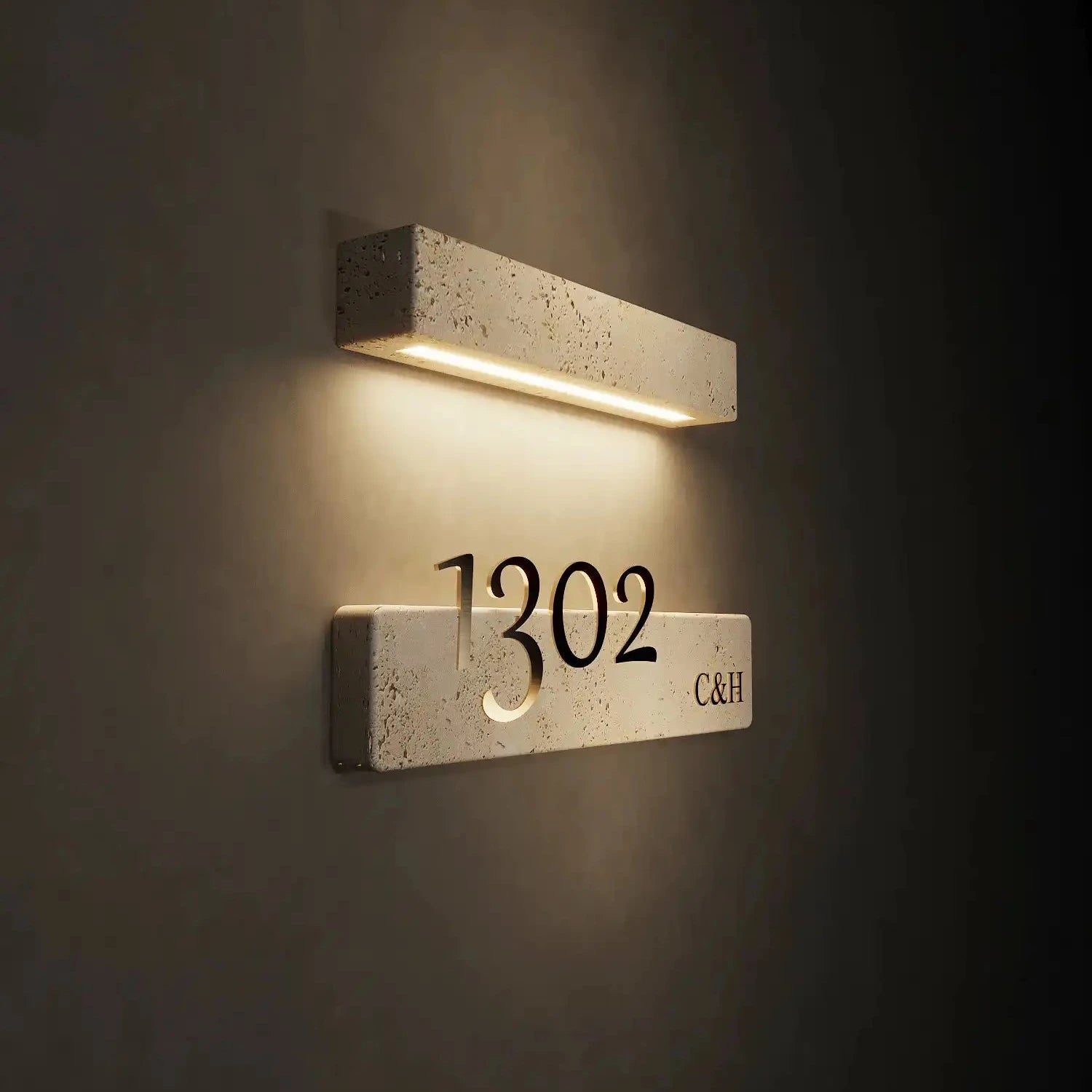 Illuminated travertine door sign with customizable house number and integrated LED light, showcasing elegant design and natural stone texture.