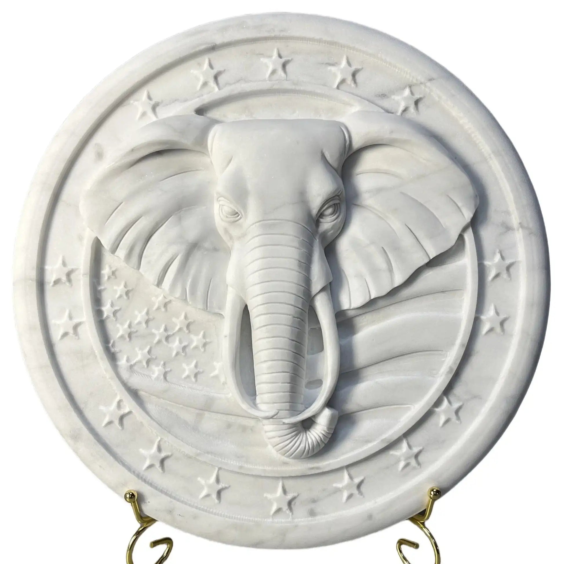 White marble relief sculpture featuring an intricately carved elephant head with star accents.